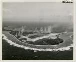 Japanese air strip on Woleai Island was rendered useless by Pacific Fleet dive bombers March 29-30, 1944. Japanese planes were demolished, installations, here going up in smoke, destroyed.