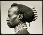 Hair decorations may extend both fore and aft as here with a young Karamojong warrior in Northern Uganda.