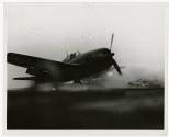Breaking loose when Ensign (now Lt. (jg)) J.G. Fraifogl, USNR, Mansfield, O., landed his Grumman HELLCAT on the TICONDEROGA  after a flight mission in the Pacific, the auxiliary gasoline tank from his plane skids across the deck.