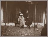 [Two men sitting on stoop]
