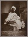 [Man seated wearing traditional Moroccon clothing]