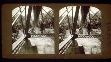 [Will Connell standing on support beam of bridge]
