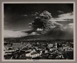 High above Naples the tremendous cascade of smoke demonstrates implacable Vesuvius' latest outbreak of wrath.