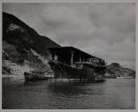 Its flight deck resembling the roof of a porch, this Japanese aircraft carrier reached journey's end in the false "security" of Kure Bay.
