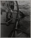 To help keep the ship on even keel after the fire, oil is pumped out to spread itself in the vast expanse of ocean.