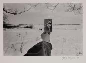 [Snowscape with hand holding postcard]
