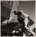 [Flight crew member running in airfield]