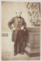 [Man with light hair and beard, standing]