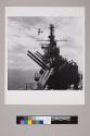 Symbolizing the close tie-line of communications between aircraft carrier and plane supplied by radar, this photograph reveals a General Moors AVENGER speeding past an ESSEX-class flattop, with the latter's radar antennae outlined against the sky.