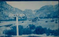 [Landscape with directional sign for city of Kyle]