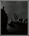 [Men on ship, anti-aircraft guns beyond]