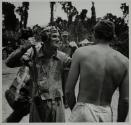 [Men conversing on front]