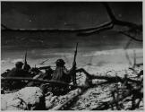 [Soldiers digging trench on beach]