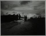 [Dead or wounded being evacuated from beach to landing craft]