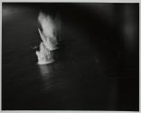 [Aerial view of water splashing in explosions around ship]