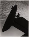 [Man and woman working on wing of plane]