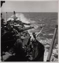 [Marine with flag on battleship]