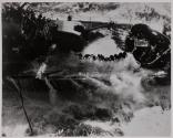 [Destroyer foredeck awash, men on cable]