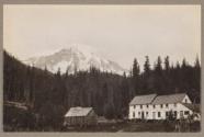 Country estate with snow capped mountain in background
