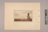 Man holding a folding Kodak looking at a scenic countryside