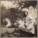 Girl sitting on a rock fence