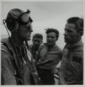 [Flight deck crew in discussion]
