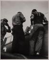 [Navy pilot in seat of plane, talking to deck crew]