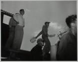 [Flight deck crew signalling]