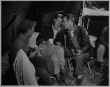 [Servicemen singing in barracks]