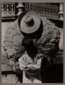 [Man with large load on back]