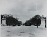 [Street scene with vehicles and people}