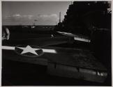 [Airplane wings on deck of carrier]