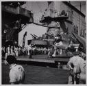 Airplane on elevator, crew on deck of aircraft carrier