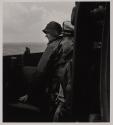[Two men on deck of ship]
