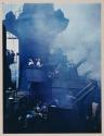 [Guns being fired from turret of a battleship]
