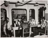 [Wounded seated around table]