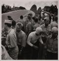 [Flight deck crowded with military personnel and airplanes]