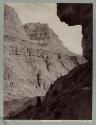 [Man with telescope in canyon on the Colorado River near Peach Springs, Arizona]