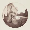 [Woman hanging laundry]