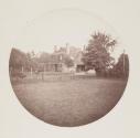 [Exterior view of the house from the lawn]