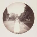 [Portrait of maid by barn]