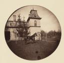 [Horse standing in front of house]
