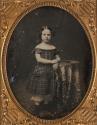 [Girl wearing plaid dress]