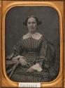 [Woman in checked dress with lace collar, seated]