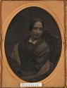 [Woman in shawl, leaning forward in chair (oval)]