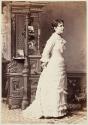 [Woman with photographs displayed behind her]