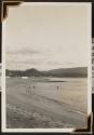 [Three people swimming at a beach in Honolulu]
