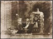 [Still life with bottle, glass and peach]