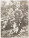 [Man resting under a tree]