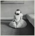 [Barbara seated on floor in Communion dress]